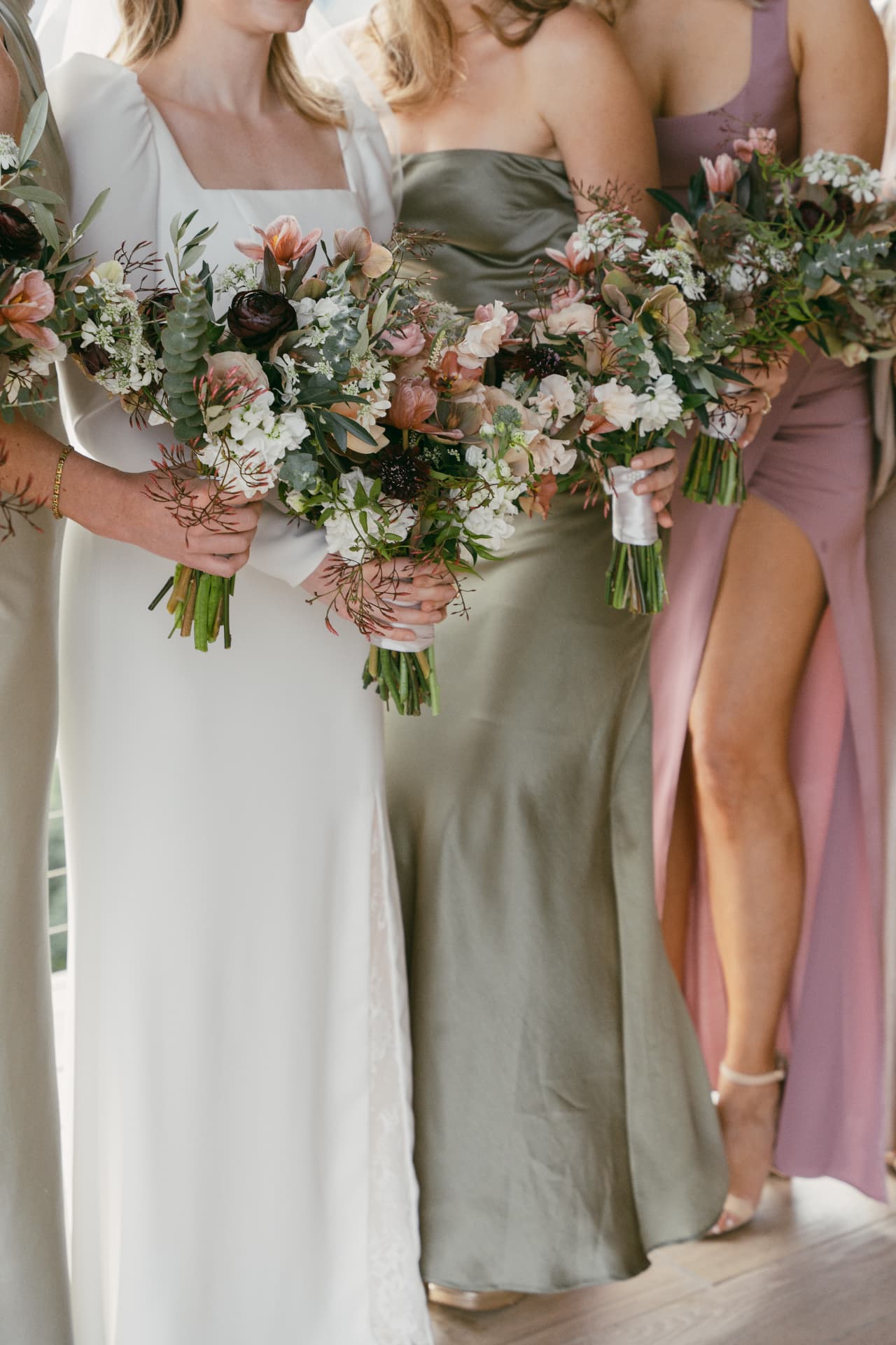Bridal party holding garden-gathered bouquets
